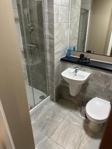 a bathroom with a shower and a toilet and a sink at Luxury Studio Apartment by Central Stay in Liverpool