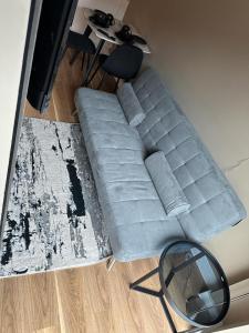 a gray couch in a living room with a mirror at Luxury Studio Apartment by Central Stay in Liverpool