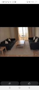 a living room with a couch and a coffee table at شقة مع اطلالة رائعة على البحر in Rabat +3 photos