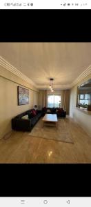 a living room with a couch and a table at شقة مع اطلالة رائعة على البحر in Rabat