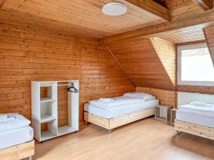 two beds in a room with wooden walls at 6 room detached house - Köln Messe Fair 10min in Cologne