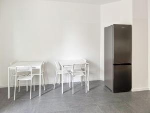 a table and chairs and a refrigerator in a room at 6 room detached house - Köln Messe Fair 10min in Cologne +18 photos