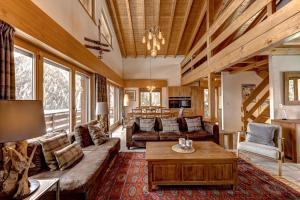 a living room with a couch and a coffee table at Chalet Coeur in La Tzoumaz