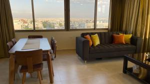 a living room with a couch and a table at Abdoun Apartment in Amman