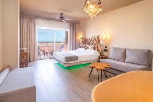 a living room with a bed and a couch at Tarifa Lances by QHotels in Tarifa