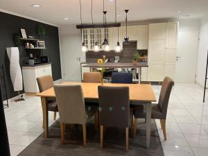 a kitchen and dining room with a wooden table and chairs at Ferienwohnung Bergblick in Kössen