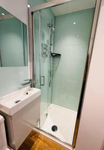 a bathroom with a shower and a sink at Upper Rock Brighton Apartments in Brighton & Hove +58 photos