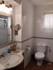 a bathroom with a sink and a toilet and a mirror at Frente al mar, Doña Carmen Playa, Mejor vista de Suances in Suances