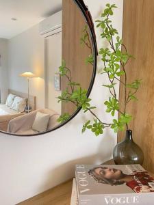 een spiegel aan een muur in een kamer met een boek bij Oceanhomes- Room love sick in Gia Lâm Pho