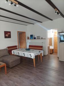 a living room with a table and a couch at Casa Veli Apartments in Offenburg +14 photos