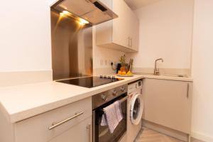 a kitchen with a sink and a dishwasher at Cosy Retreat in the heart of Preston in Preston