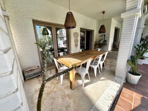 a wooden table and chairs on a patio at Villa de lujo en playamar in Torremolinos