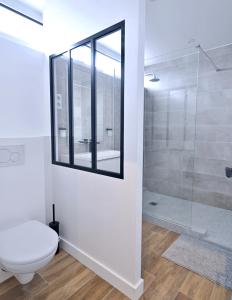 a bathroom with a toilet and a glass shower at Duplex Near Paris/ RER 4 bedrooms 100m2 Balcony in Meudon