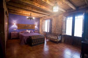 a bedroom with a bed and a crib in a room at Casa Rural Inma, Segovia ,Hoces del Duraton y cerca de Madrid in Muñoveros +137 photos
