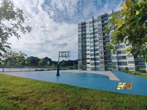 a basketball hoop in front of a large building at Stylish Apartment and Cozy Feel in Kuching