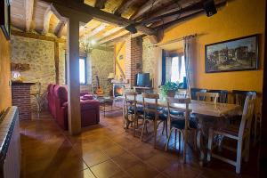 a living room with a table and chairs and a couch at Casa Rural Inma, Segovia ,Hoces del Duraton y cerca de Madrid in Muñoveros