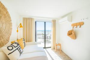 a living room with a white couch and a view of the ocean at Casa na Muralha - Beach front - Rooftop Jacuzzi by DreamvillasAlbufeira in Albufeira