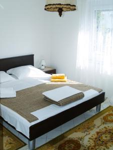a bedroom with a bed with a laptop on it at Apartment Marijana, Free Parking in Selce