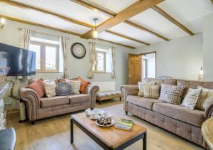 a living room with two couches and a coffee table at Llysfaen Cottage in Cray