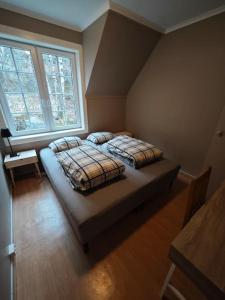 a bedroom with two beds in front of a window at Rekkehus Tyssedal Trolltunga in Tveit