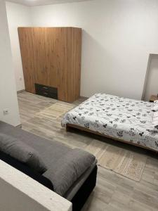 a bedroom with two beds and a wooden cabinet at Apartman Kastel in Kaštela