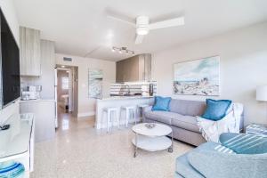 a living room with a couch and a table at Boutique Vacation Rental Complex At Beach in Cocoa Beach