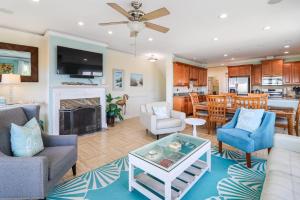 a living room filled with furniture and a fireplace at Ocean Queen in Tybee Island