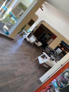 a living room with chairs and a book store at Hotel Suiza in Termas de Río Hondo