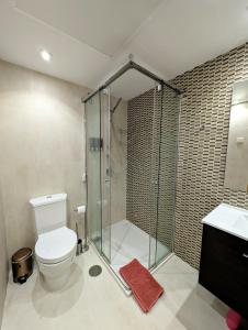 uma casa de banho com um chuveiro, um WC e um lavatório. em Apartments 1418 San Pedro em Marbella