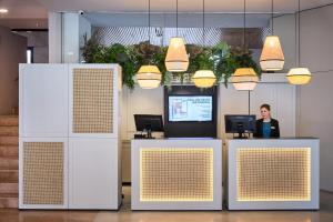 a woman standing at a counter in an office at Catalonia Sabadell in Sabadell