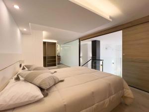 a bedroom with a large bed with a large window at Loft Rambla in Santa Cruz de Tenerife