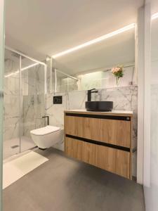a bathroom with a sink and a toilet and a shower at Loft Rambla in Santa Cruz de Tenerife