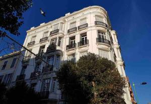 a white building with balconies and a bird on top at Elegant Bel Epoque Apartment In Center Of Menton in Menton