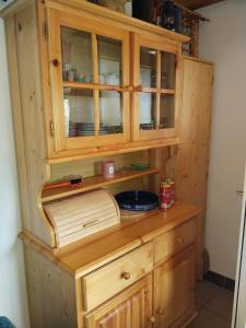 a wooden cabinet with a bowl inside of it at Wooden Treasure in Jesenice