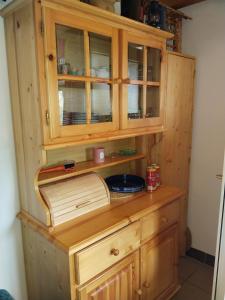 a wooden cabinet with a bowl inside of it at Wooden Treasure in Jesenice +8 photos
