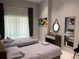 a bedroom with two beds and a mirror at Luxury 3-bedroom apartment in St Julians in St. Julianʼs