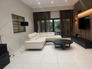a living room with a couch and a table at Luxury 3-bedroom apartment in St Julians in St. Julianʼs