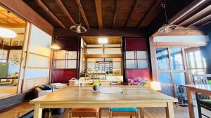 a large dining room with a wooden table and chairs at 農家民宿と古民家カフェ 里山のカフェ ににぎ in Oga +52 photos