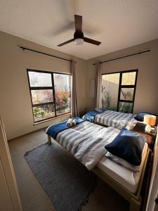 a bedroom with two beds and a window at Astra Self-Catering Apartments in Swakopmund