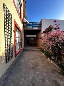 a brick walkway leading to a building with a patio at Astra Self-Catering Apartments in Swakopmund