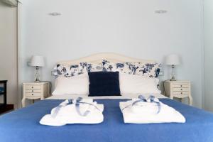 a bedroom with a blue bed with towels on it at Central View Boutique in Florence