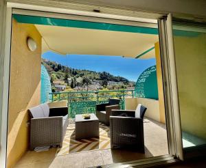 a balcony with chairs and a view of a mountain at quiet studio swimming pool Roquebrune in Roquebrune-Cap-Martin