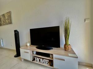 a flat screen tv sitting on top of a entertainment center at quiet studio swimming pool Roquebrune in Roquebrune-Cap-Martin +19 photos