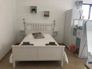 a bedroom with a white bed in a room at Las Buganvillas 77 in Playa Blanca