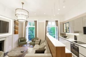 a living room with a couch and a table at Holland Park Residence in London