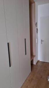 a room with a white cabinet and a hallway at M&M2 Brand new apartment near center with parking in Košice