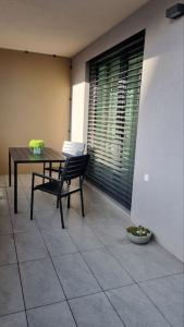 a table and a chair sitting on a patio at M&M2 Brand new apartment near center with parking in Košice