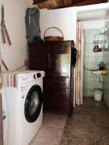 a laundry room with a washing machine in a bathroom at Aphrodite 's cottage in Milopotamos