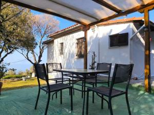 a table and chairs sitting on a patio at Aphrodite 's cottage in Milopotamos