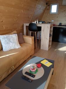 a living room with a couch and a table at Vikendica "Koliba kraj puta" in Divčibare +35 photos